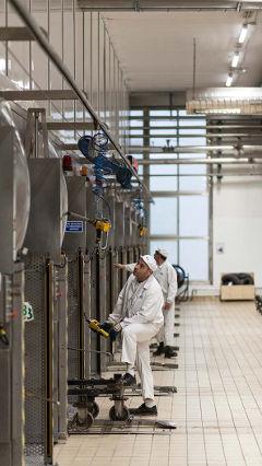 Men work at Hero factory in Spain, which is lit using Philips energy-saving LED lighting