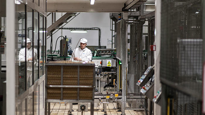 An employee works at Hero factory, illuminated by Philips energy-saving food industry LED lighting