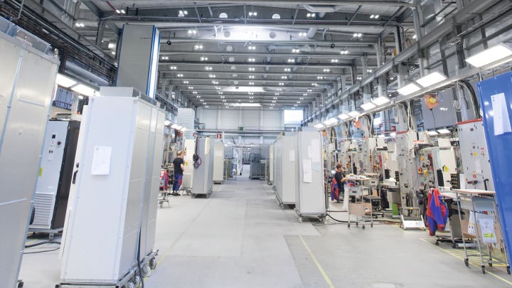 Staff working efficiently at ABB Drives lit by Philips Lighting