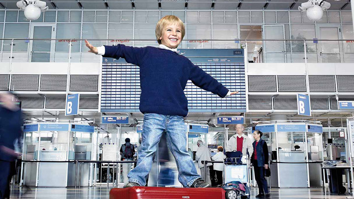 Kid playing in a well illuminated airport terminal