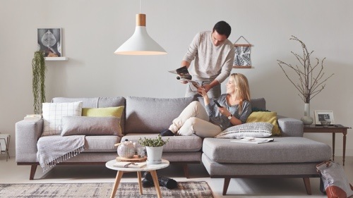 Two people sitting on the couch at home enjoying high quality LED light 