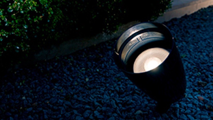 A Philips LED flood light lighting a garden