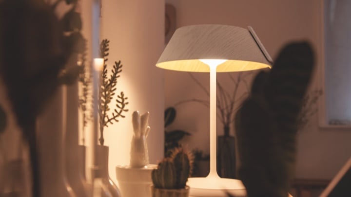 Table lamp lighting a living room cabinet