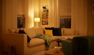 "Cosy living room illuminated by warm LED lighting, showcasing energy-efficient home ambiance with smart bulbs"