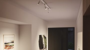 Ceiling spotlights in the hallway aimed at coats